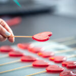 Close-up, the process of making heart-shaped lollipops.